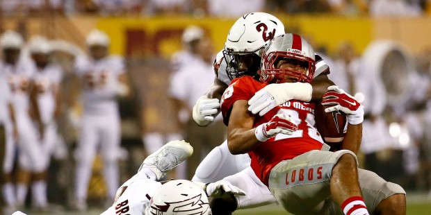 New Mexico running back David Anaya (25) is stopped by Arizona State linebacker Christian Sam (2) a...