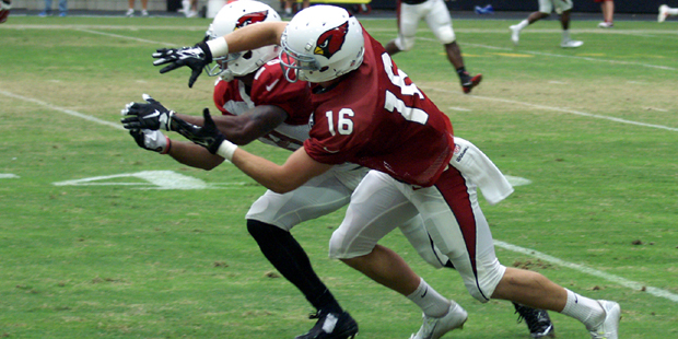 Receiver Jaxon Shipley and cornerback Justin Bethel battle for a football during training camp Aug....