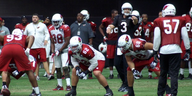 QB Carson Palmer directs the offense during training camp Aug. 24. (Photo: Adam Green/Arizona Sport...