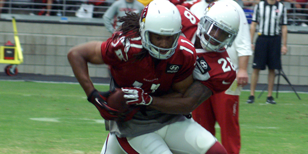 Receiver Larry Fitzgerald makes a catch while cornerback Justin Bethel covers during Arizona Cardin...