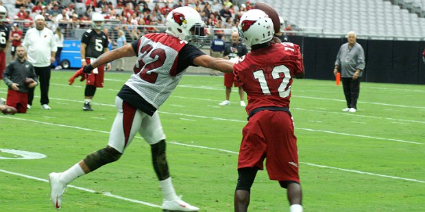 Tyrann Mathieu reaches in to bat away a pass intended for John Brown during Arizona Cardinals train...