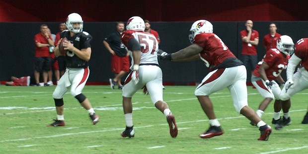 Alex Okafor (57) applies pressure as QB Drew Stanton looks for a receiver during Cardinals training...