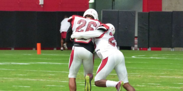 Defensive backs Rashad Johnson and Jerraud Powers work on a drill at University of Phoenix Stadium ...