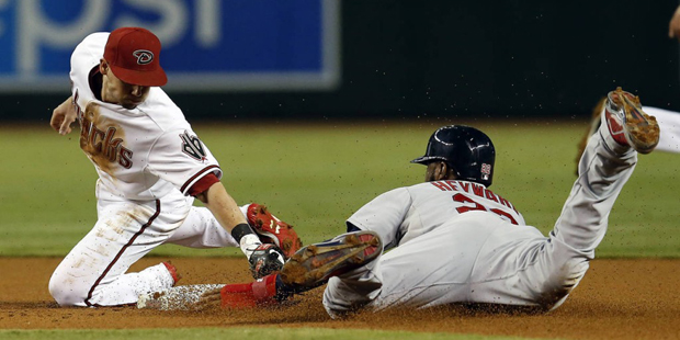 St. Louis Cardinals’ Jason Heyward, right, steals second base in front of Arizona Diamondback...