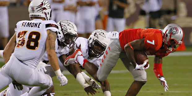 New Mexico running back Teriyon Gipson (7) is chased by Arizona State defenders during the first ha...