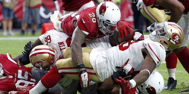 San Francisco 49ers running back Carlos Hyde (28) is tackled in the end zone for a safety by Arizon...
