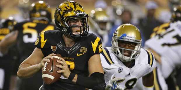 Arizona State quarterback Mike Bercovici (2) scrambles under pressure from UCLA linebacker Deon Hol...