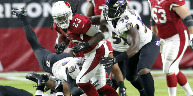 Arizona Cardinals running back Chris Johnson (23) runs as Baltimore Ravens outside linebacker Elvis...