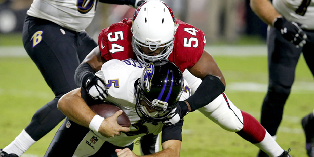 Baltimore Ravens quarterback Joe Flacco (5) is sacked by Arizona Cardinals linebacker Dwight Freene...