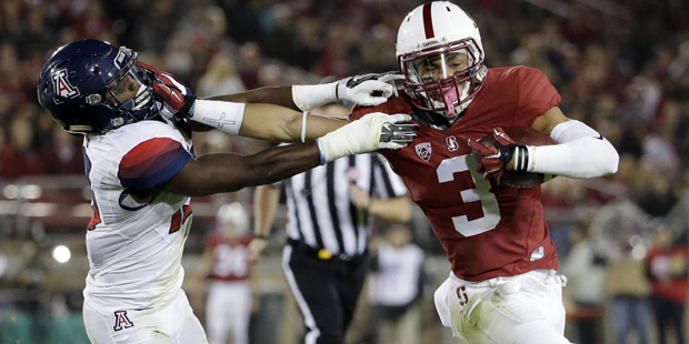 Stanford's Michael Rector (3) stiff arms Arizona 's DaVonte' Neal on an 18-yard touchdown reception...