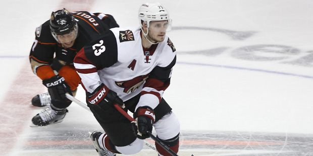 Arizona Coyotes' Oliver Ekman-Larsson (23) controls the puck in front of Anaheim Ducks' Andrew Cogl...