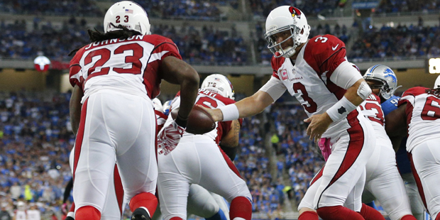 Arizona Cardinals quarterback Carson Palmer (3) hands the ball to running back Chris Johnson (23) d...