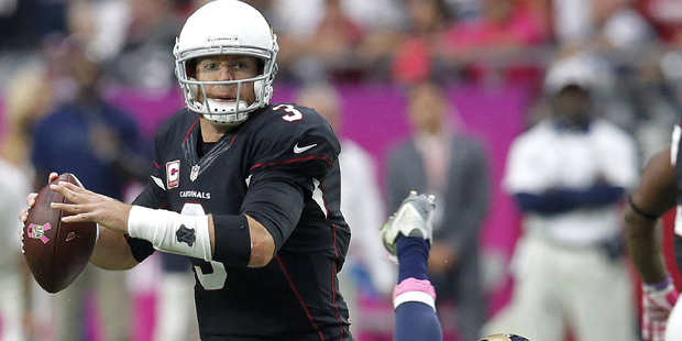 Arizona Cardinals quarterback Carson Palmer (3) looks to throw under pressure from St. Louis Rams s...