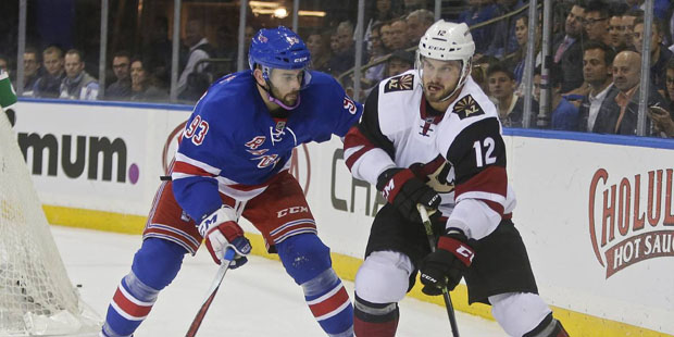 New York Rangers' Keith Yandle (93) defends Arizona Coyotes' Brad Richardson (12) during the first ...