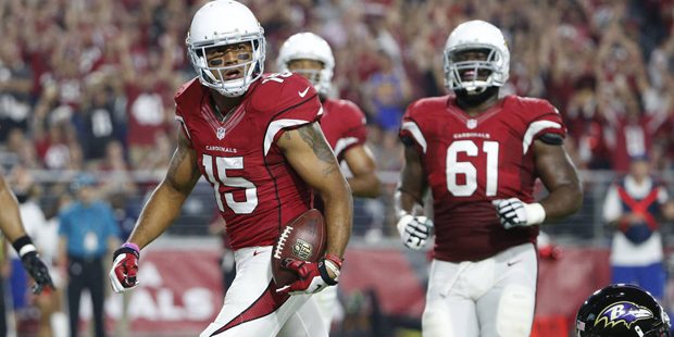 Arizona Cardinals wide receiver Michael Floyd (15) scores a touchdown as Baltimore Ravens linebacke...