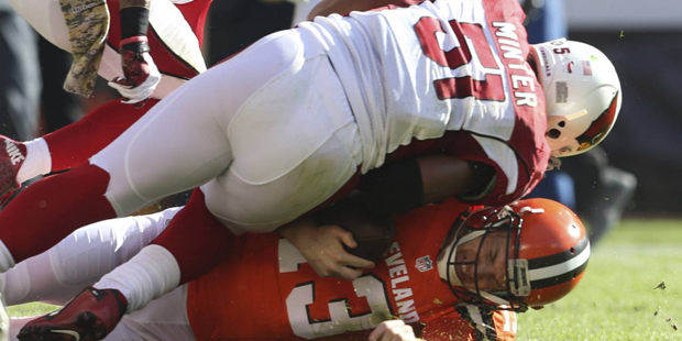 Cleveland Browns quarterback Josh McCown (13) is tackled by Arizona Cardinals middle linebacker Kev...