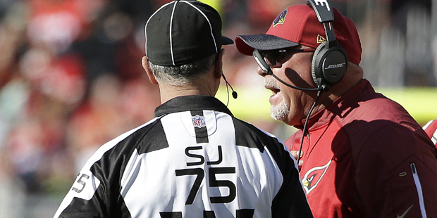 Arizona Cardinals head coach Bruce Arians, center, talks with side judge Rob Vernatchi (75) during ...