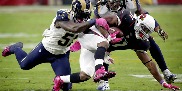 Arizona Cardinals running back David Johnson (31) his hit by St. Louis Rams outside linebacker Alec...