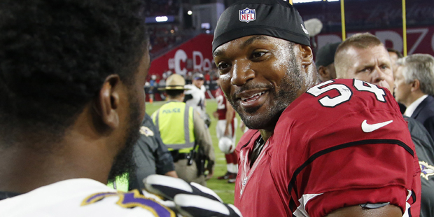 Arizona Cardinals' Dwight Freeney (54) talks with Baltimore Ravens' Shareece Wright, left, after an...