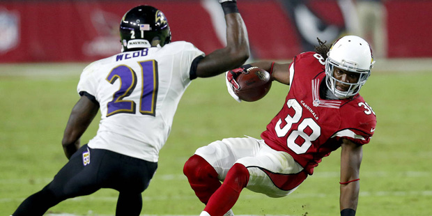 Arizona Cardinals running back Andre Ellington (38) tries to elude Baltimore Ravens cornerback Lard...