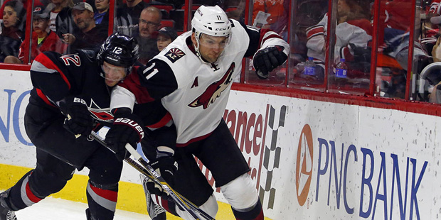 Carolina Hurricanes' Eric Staal (12) battles with Arizona Coyotes' Martin Hanzal (11) during the fi...