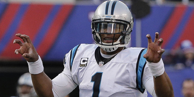 FILE - In this Dec. 20, 2015, file photo, Carolina Panthers quarterback Cam Newton calls an audible...