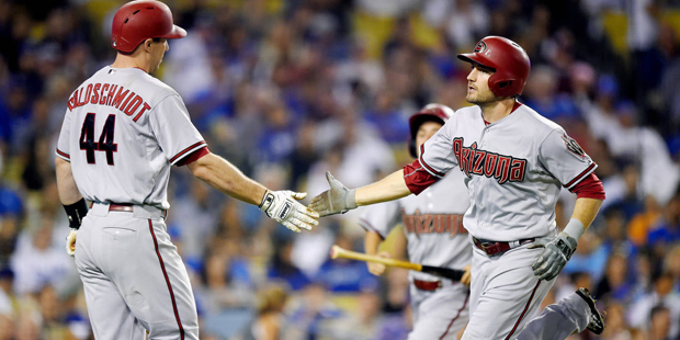 Arizona Diamondbacks' A.J. Pollock, right, is congratulated by Paul Goldschmidt after hitting a sol...