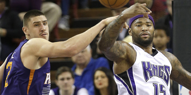 Phoenix Suns center Alex Len, left, and Sacramento Kings forward DeMarcus Cousins go for a rebound ...