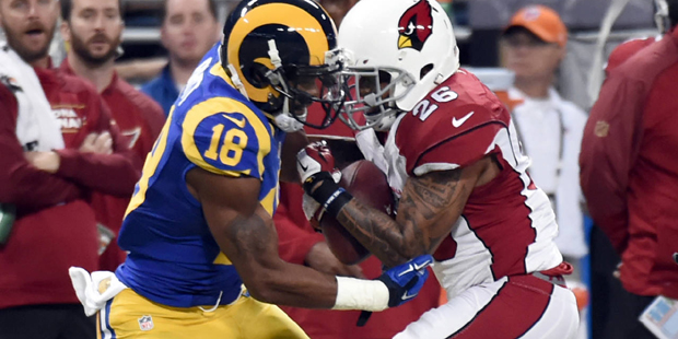 Arizona Cardinals free safety Rashad Johnson, right, intercepts a pass intended for St. Louis Rams ...