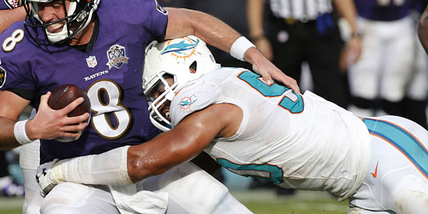Baltimore Ravens quarterback Matt Schaub (8) is sacked by Miami Dolphins defensive end Olivier Vern...