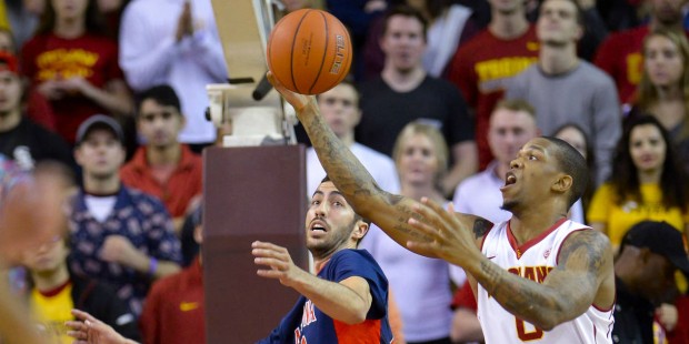 Arizona forward Mark Tollefsen, left, and Southern California forward Darion Clark (0) fight for th...