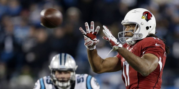 Arizona Cardinals' Larry Fitzgerald catches a pass in front of Carolina Panthers' Luke Kuechly duri...