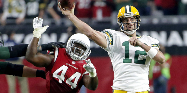 Green Bay Packers quarterback Aaron Rodgers (12) throws under pressure from Arizona Cardinals outsi...