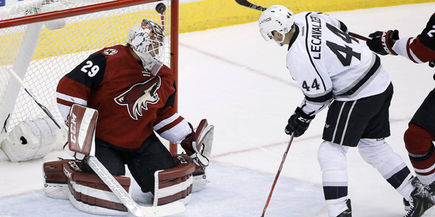 Los Angeles Kings' Vincent Lecavalier (44) flips the puck over Arizona Coyotes' Anders Lindback (29...