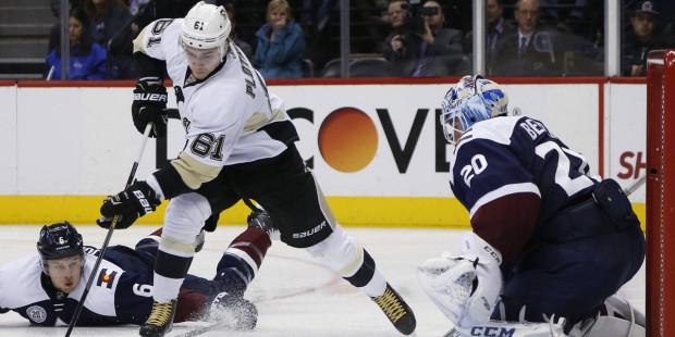 Pittsburgh Penguins left wing Sergei Plotnikov, center, of Russia, skates past Colorado Avalanche d...