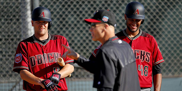 Arizona Diamondbacks pitchers Andrew Chafin. left, and Randall Delgado (48) get instructions during...