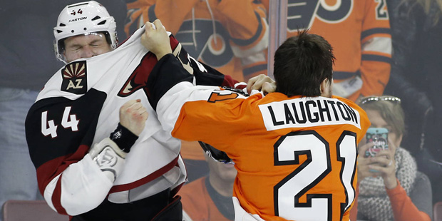 Arizona Coyotes' Kevin Connauton, left, and Philadelphia Flyers' Scott Laughton fight during the se...
