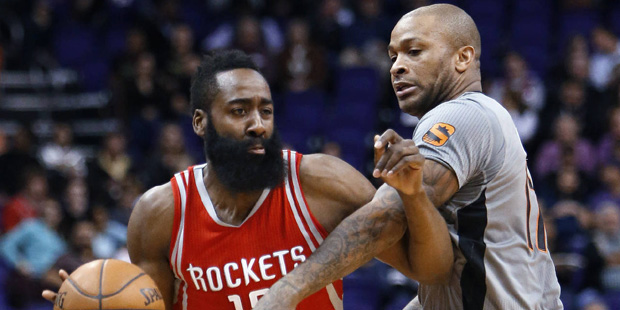 Houston Rockets guard James Harden, left, drives on Phoenix Suns forward P.J. Tucker in the first q...