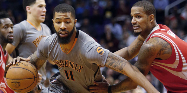 Phoenix Suns forward Markieff Morris (11) drives past Houston Rockets forward Trevor Ariza during t...