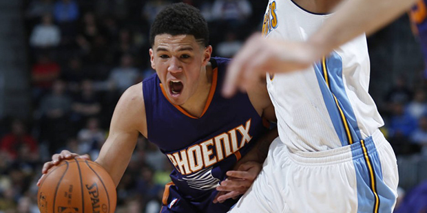 Phoenix Suns guard Devin Booker (1) reacts in the second half of an NBA basketball game against the...