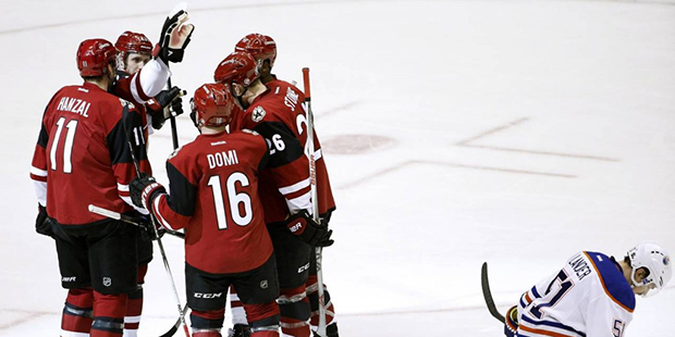 Arizona Coyotes' Martin Hanzal (11), of the Czech Republic, celebrates his goal with Max Domi (16),...
