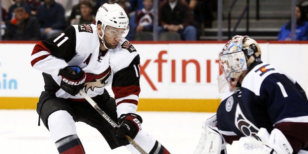 Arizona Coyotes center Martin Hanzal, left, of the Czech Republic, has his shot stopped by Colorado...