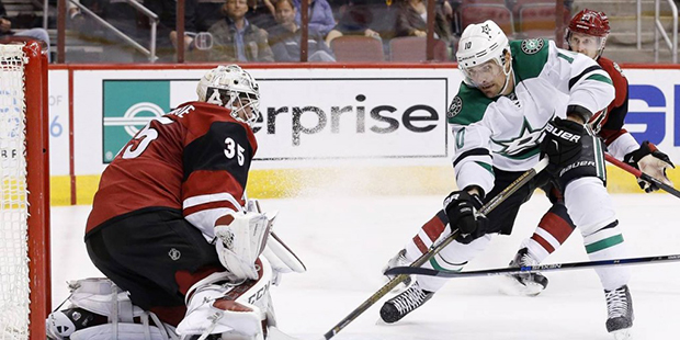 Arizona Coyotes' Louis Domingue (35) makes a save on a shot by Dallas Stars' Patrick Sharp (10) dur...