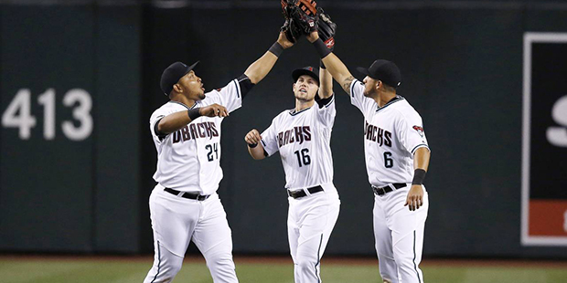 Arizona Diamondbacks' Yasmany Tomas (24), Chris Owings (16) and David Peralta (6) celebrate after t...