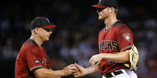 Arizona Diamondbacks pitcher Shelby Miller, right, is removed from the game by manager Chip Hale af...