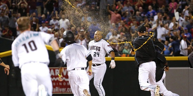 Arizona Diamondbacks Yasmany Tomas (24) celebrates with teammates after hitting the game-winning ba...