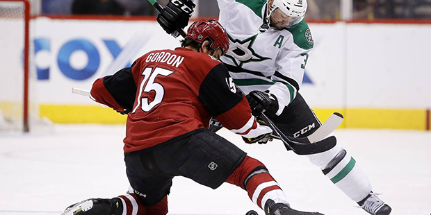 Dallas Stars' Vernon Fiddler (38) and Arizona Coyotes' Boyd Gordon (15) battle on a face off during...
