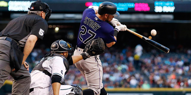 Colorado Rockies' Trevor Story (27) fouls off a pitch as Arizona Diamondbacks' Welington Castillo, ...