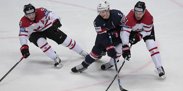 Canada’s Matt Duchene, left, and Mark Stone, right, struggle for a puck with Connor Murphy of the...
