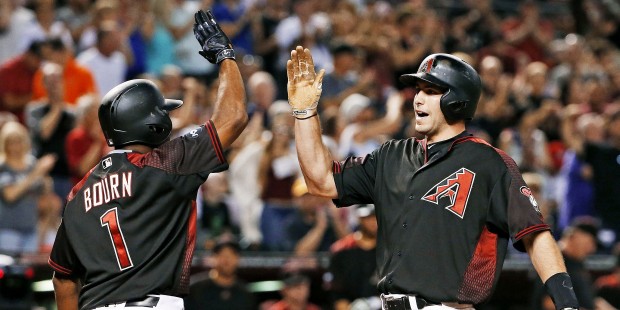 Arizona Diamondbacks' Paul Goldschmidt, right, celebrates his two-run home run against the San Dieg...